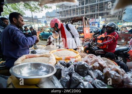 Vendor selling Assamese traditional food in a market, ahead of Magh Bihu Festival in Guwahati, Assam, India on 13 January 2024. Magh Bihu marks the end of the harvesting season, particularly the harvesting of paddy, and the beginning of the Assamese month of Magh. The festival usually falls in mid-January, and it is a time of joy and feasting. People express gratitude for the bountiful harvest and pray for prosperity in the coming seasons. Credit: David Talukdar/Alamy Live News Stock Photo