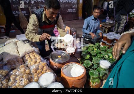 Vendor selling Assamese traditional food in a market, ahead of Magh Bihu Festival in Guwahati, Assam, India on 13 January 2024. Magh Bihu marks the end of the harvesting season, particularly the harvesting of paddy, and the beginning of the Assamese month of Magh. The festival usually falls in mid-January, and it is a time of joy and feasting. People express gratitude for the bountiful harvest and pray for prosperity in the coming seasons. Credit: David Talukdar/Alamy Live News Stock Photo