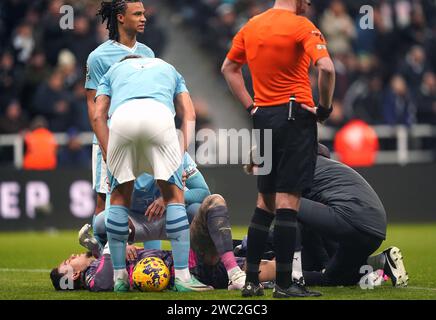 Manchester City goalkeeper Ederson receives treatment for an injury during the Premier League match at St. James' Park, Newcastle upon Tyne. Picture date: Saturday January 13, 2024. Stock Photo