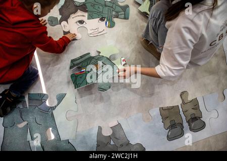 Moscow, Russia. 13th of January, 2024. People assemble a large outdoor puzzle on the stand of Belgorod region during the Russia Expo international exhibition and forum at the VDNKh exhibition centre in Moscow, Russia Stock Photo