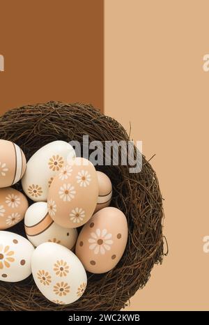 Peach & white painted easter eggs on a beige & brown background Stock Photo