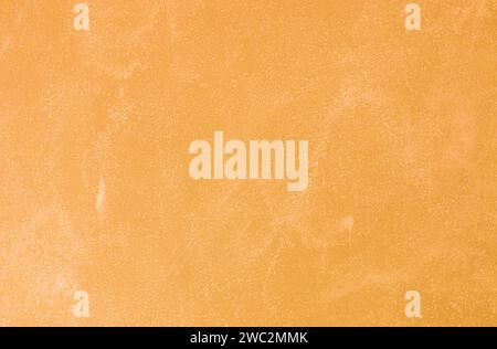 Texture of old orange plaster damaged by weather. Stock Photo