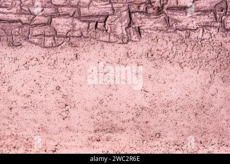 Wall surface with peeling magenta paint. Rusty iron surface. Stock Photo