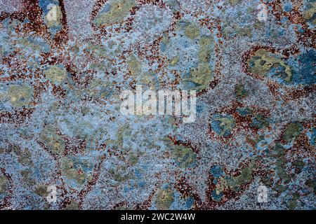 Cracked shabby multicolor textured background with spots. The metal surface rusted spots. Peeling paint Stock Photo