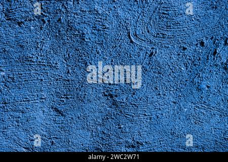 Fragment of a wall painted with blue paint. Blue stucco texture. Designer interior background. Stock Photo