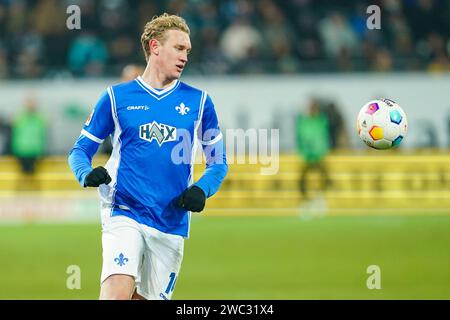 Darmstadt, Germany. 13th Jan, 2024. Soccer: Bundesliga, SV Darmstadt 98 - Borussia Dortmund, Matchday 17, Merck Stadium at Böllenfalltor. Darmstadt's Christoph Klarer plays the ball. Credit: Uwe Anspach/dpa - IMPORTANT NOTE: In accordance with the regulations of the DFL German Football League and the DFB German Football Association, it is prohibited to utilize or have utilized photographs taken in the stadium and/or of the match in the form of sequential images and/or video-like photo series./dpa/Alamy Live News Stock Photo