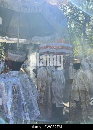 Gondar, Ethiopia, 19 January 2023; Group of Orthodox priests walking through incense smoke, against light, celebrating Timkat, Ethiopian Orthodox cele Stock Photo