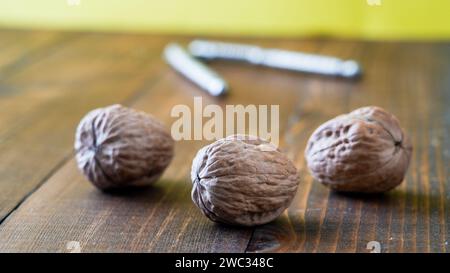 Three walnuts on wooden table Stock Photo