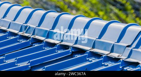 Closeup of roof covered with blue metal corrugated roofing tiles Stock Photo