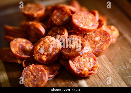 Sliced chorizo sausage on a wooden chopping board Stock Photo