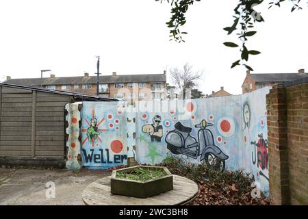 Sheerwater, Woking, Surrey. Wall mural with graffiti showing Paul Weller and scooter and name of The Jam Stock Photo