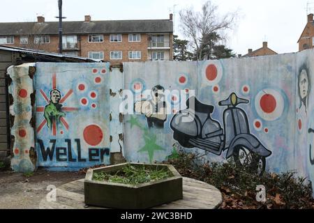 Sheerwater, Woking, Surrey. Wall mural with graffiti showing Paul Weller and scooter and name of The Jam Stock Photo