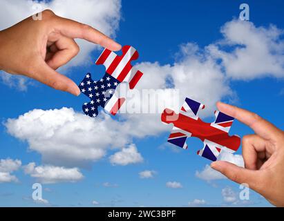 Puzzle pieces, Two hands each holding a puzzle piece, USA, Great Britain, Studio Stock Photo