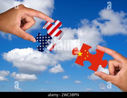 Puzzle pieces, Two hands each holding a puzzle piece, USA, China, Studio Stock Photo