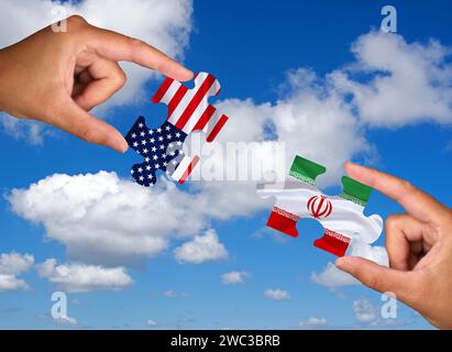 Puzzle pieces, Two hands each holding a puzzle piece, USA, Iran, Studio Stock Photo