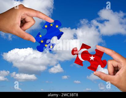 Puzzle pieces, Two hands each holding a puzzle piece, Europe, Turkey, War, Syria, Kurdistan, Studio Stock Photo