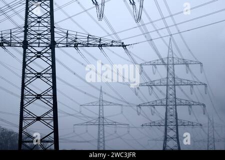 Strommasten stehen auf einem Feld in der Nähe von Industrieanlagen bei Köln. Unternehmen aus allen Branchen klagen über hohe Strompreise. Verschärft hat sich das seit dem Ukraine-Krieg und der darauf folgenden Energiepreiskrise. Themenbild, Symbolbild. Köln, 13.01.2024 NRW Deutschland *** Electricity pylons stand in a field near industrial plants near Cologne Companies from all sectors are complaining about high electricity prices This has worsened since the war in Ukraine and the subsequent energy price crisis Themed image, symbolic image Cologne, 13 01 2024 NRW Germany Copyright: xChristophx Stock Photo