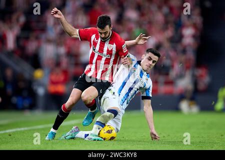 BILBAO, SPAIN - JANUARY 13: Inigo Lekue of Athletic Club competes for the ball with Ander Barrenetxea of Real Sociedad during the LaLiga EA Sports match between Athletic Club and Real Sociedad at Estadio de San Mames on January 13, 2024 in Bilbao, Spain. (Photo by QSP) Stock Photo