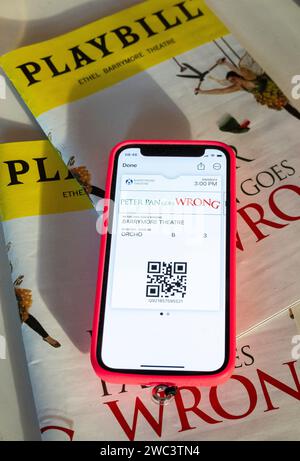 Playbills and Tickets on iPhone, Peter Pan Goes Wrong, 2023, NYC, USA Stock Photo