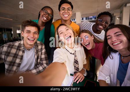 A large group of smiling and cheerful young multiracial university students taking a selfie  Stock Photo