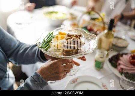 Traditional Easter breakfast food in Lithuania. Lithuanians also include a variety of cold dishes, freshly baked bread, boiled painted eggs, hams, sau Stock Photo