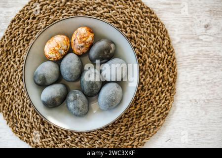 Colorful Easter eggs hand-painted at home. Using natural food coloring to dye Easter eggs. Painting eggs with herbs and onion peels. Getting ready for Stock Photo