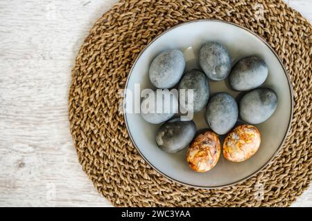 Colorful Easter eggs hand-painted at home. Using natural food coloring to dye Easter eggs. Painting eggs with herbs and onion peels. Getting ready for Stock Photo