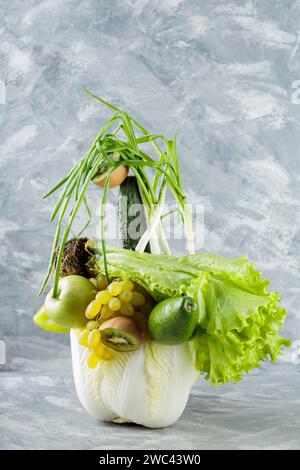 Levitating Fresh Green Fruits and Vegetables on Gray Concrete Background Stock Photo
