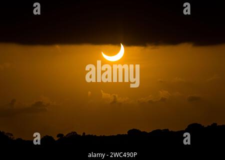 Partial Solar Eclipse of October 14, 2023 during sunset as seen from Natal, a city in Brazil Stock Photo