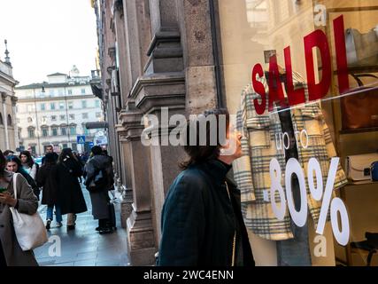 Rome, Italy. 13th Jan, 2024. A woman looks through the window of a boutique in Rome, Italy, Jan. 13, 2024. Credit: Li Jing/Xinhua/Alamy Live News Stock Photo