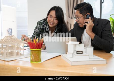 Architects and owner working on construction site. Stock Photo