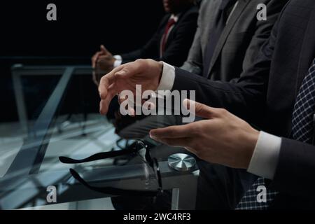 Business partners discuss financial reports, plan an investment strategy. Team of three Stock Photo
