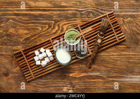 Composition with matcha tea, ingredients and accessories on wooden background Stock Photo