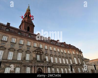 Kopenhagen, Denmark. 14th Jan, 2024. Danish flags are raised at Christiansborg Palace. After 52 years of regency, the long-serving Queen Margrethe II will hand over the throne on Sunday to her son Crown Prince Frederik, who will bear the title King Frederik X in future. Denmark's Prime Minister Frederiksen will proclaim the new monarch from the palace balcony in the afternoon. Credit: Steffen Trumpf/dpa/Alamy Live News Stock Photo
