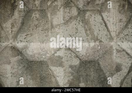 Abstract pattern, gray concrete fence. Concrete trapezoid paver blocks. Design geometric mosaic texture for the decoration. Seamless embossment patter Stock Photo