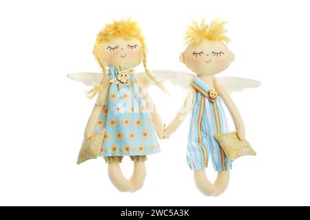 Beautiful blonde doll couple young man and woman isolated on white background. Blue and yellow color natural cotton linen material, handmade toy or in Stock Photo