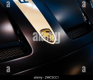 Porsche logotype closeup on car hood. Novi Sad, Serbia - 09.08.2023. Stock Photo