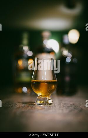 crystal brandy glass on the oak table with bottle Stock Photo - Alamy