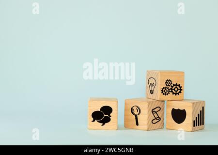 Business idea, Symbol, Conceptual icons on wooden blocks, Market observation, analysis, good team and teamwork, Customer protection, Stable growth, co Stock Photo