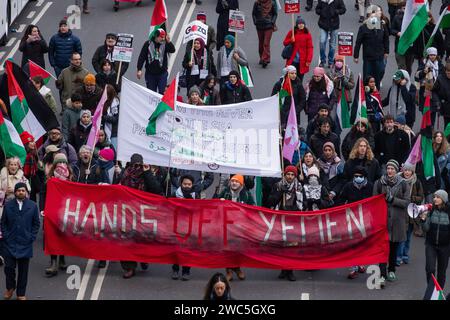 London, UK. 13th January, 2024. Pro-Palestinian protesters march behind a banner reading 'Hands Off Yemen' during a Global Day of Action to call for an immediate ceasefire in Gaza. The march, from the City of London to Westminster, was organised by Palestine Solidarity Campaign, Stop the War Coalition, Friends of Al-Aqsa, Muslim Association of Britain, Palestinian Forum in Britain and CND. Credit: Mark Kerrison/Alamy Live News Stock Photo