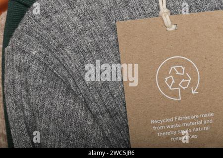 Close up of clothing tag with recycle icon. Recycling products concept. Zero waste, suistainale production, environment care and reuse concept. Stock Photo