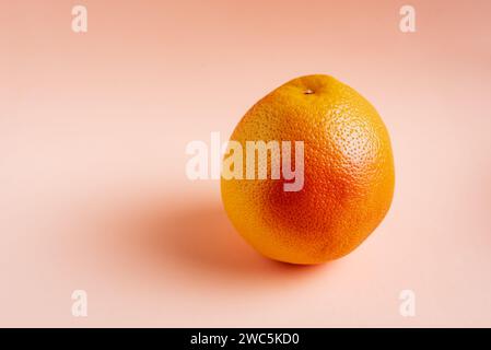 Ripe grapefruit close-up on pink background. Stock Photo