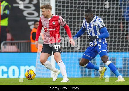 Southampton midfielder Stuart Armstrong  (17) battles with Sheffield Wednesday defender Bambo Diaby  (5)  during the Southampton FC v Sheffield Wednesday FC sky bet EFL Championship match at St.Mary's Stadium, Southampton, England, United Kingdom on 13 January 2024 Stock Photo