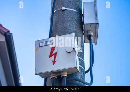 Electrical box on a concrete pole in the village. Electrical equipment Stock Photo