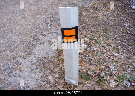 Orange barrels, barricades, and signs blocking a road Stock Photo