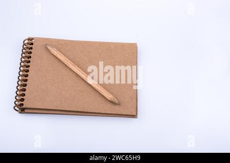 Pencil placed on a notebook on a white background Stock Photo