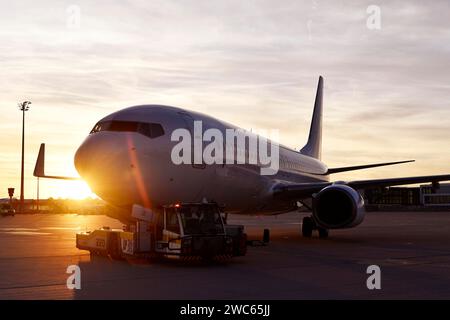 Airbus aircraft towing with push back vehicle in the sunset, Munich Airport, Upper Bavaria, Bavaria, Germany Stock Photo