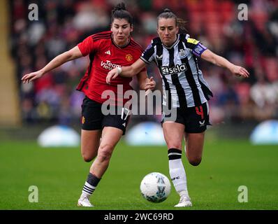 Manchester United's Lucia Garcia (left) and Newcastle United's Amber-Keegan Stobbs during the Adobe Women's FA Cup fourth round match at the Leigh Sports Village Stadium, Manchester. Picture date: Sunday January 14, 2024. Stock Photo