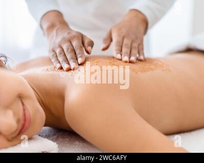 Unrecognizable woman receiving a rejuvenating back scrub Stock Photo
