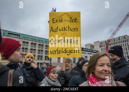 Berlin, Germany. 14th Jan, 2024. In an unparalleled show of solidarity, the streets of Berlin on January 14, 2024, echoed with the voices of 25,000 protesters as they converged at Pariser Platz in the shadow of the iconic Brandenburg Gate. The demonstration, orchestrated by Fridays for Future Berlin and backed by an extensive coalition of civil society groups, NGOs, and activists, marked a decisive stand against right-wing extremism and a relentless defense of democratic values. Under the theme ''We Stand Together'' was a direct response to the chilling findings of an investigative report by Stock Photo